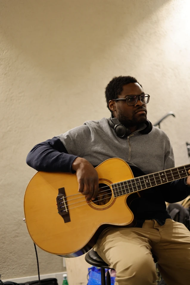 a musician playing his guitar